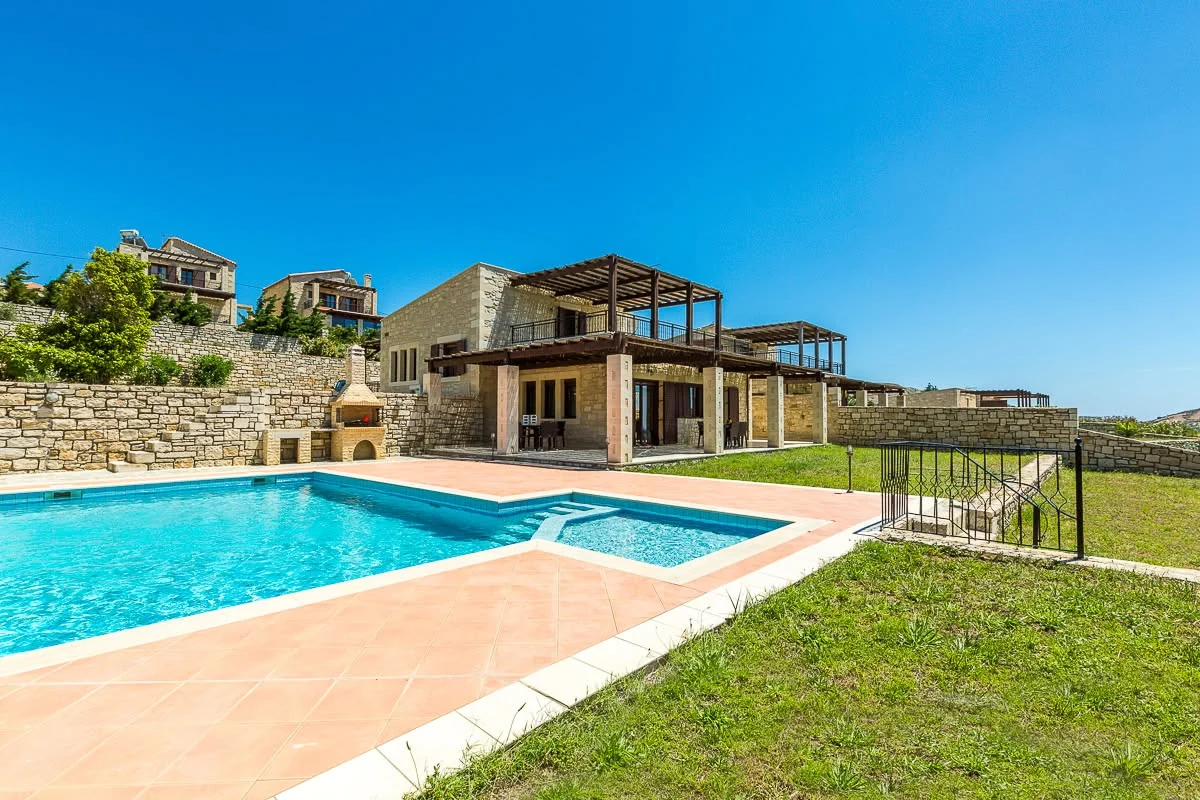 Pool and stone villa by day