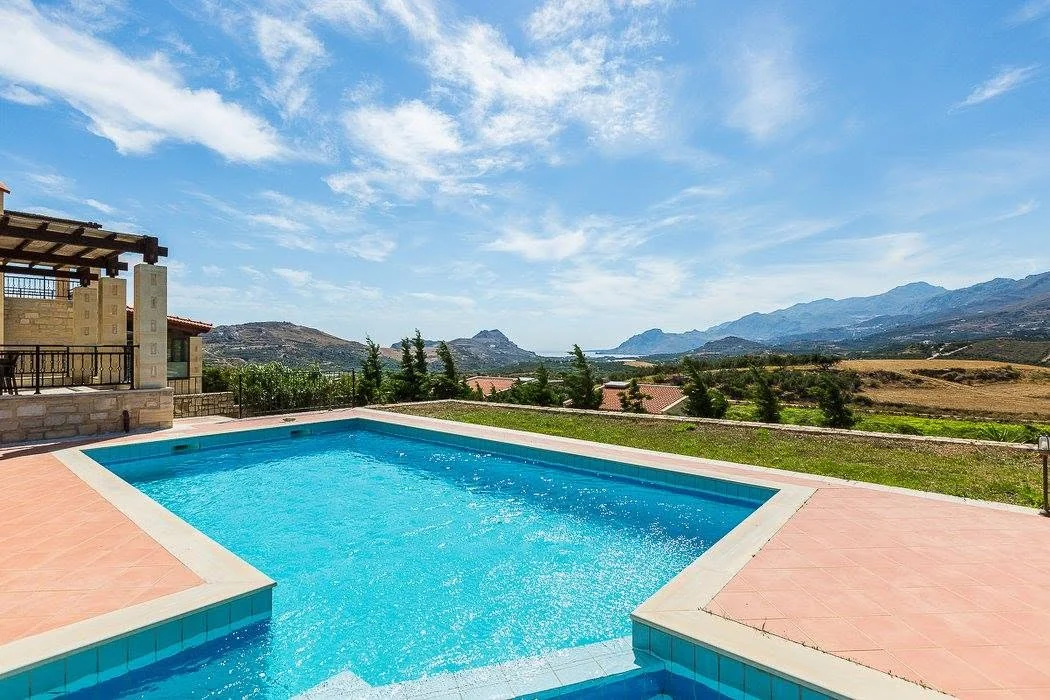 Pool and stone villa by day
